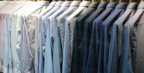 istock Looking At Shirts Hanging On A Rail Rack In Retail Store 1010675618