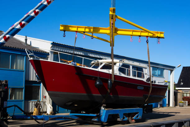 Motorboat on a crane Boat crane lifting a motorboat motorboat maintenance stock pictures, royalty-free photos & images