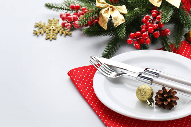 istock Kitchen cutlery with plate and christmas decorations on white background 1010679092