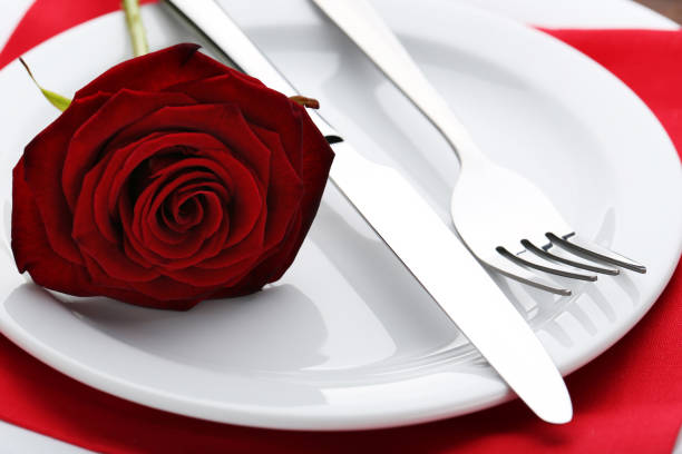 istock Kitchen cutlery with red rose in white plate 1010679140