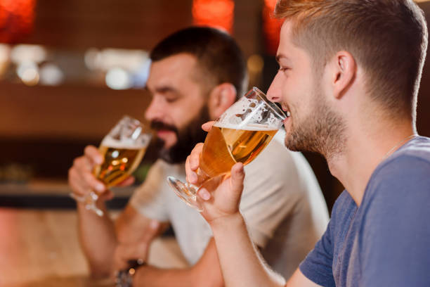istock Two bearded men drinking beer in cafe. 1010682360