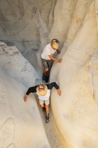 istock Two Brothers Hiking Through A Slot Canyon 1010682666