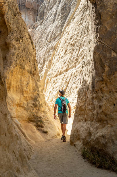 istock A Man Hiking Through a Slot Canyon 1010687344