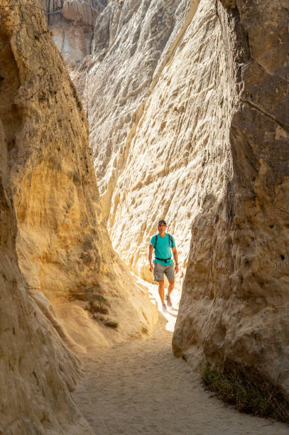istock A Man Hiking Through a Slot Canyon 1010687400