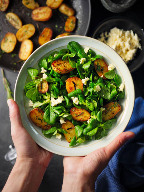 Healthy Summer potatoes Salad Home made freshness roasted baby potatoes with rosemary, garlic and mix with lamb's lettuce salad, sprinkle  feta flakes. corn salad stock pictures, royalty-free photos & images