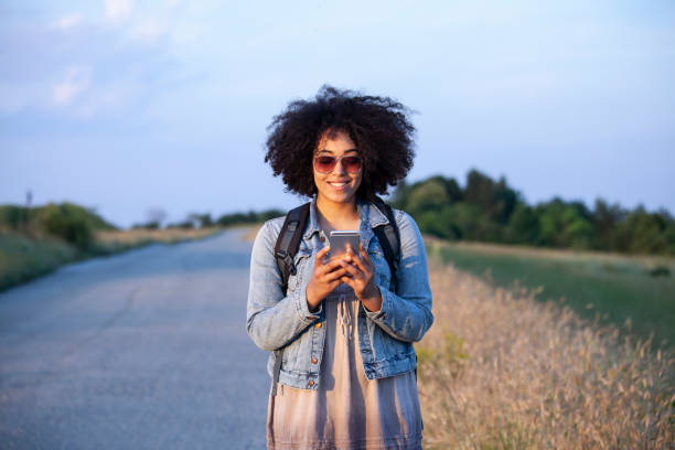 istock African woman using smart phone on country road 1010693068