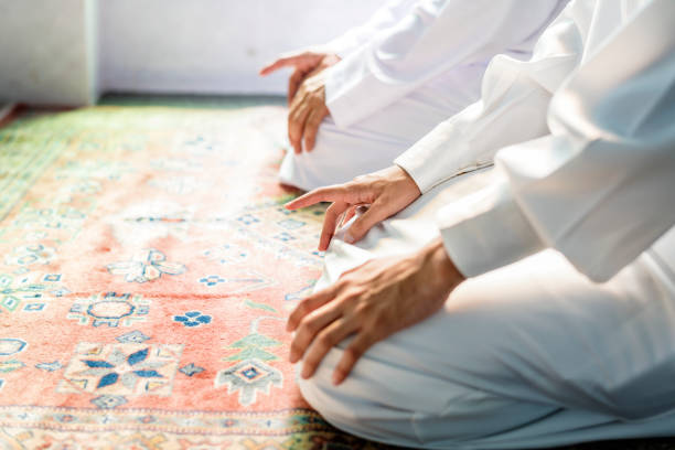 istock Muslim men praying in Tashahhud posture 1010697354