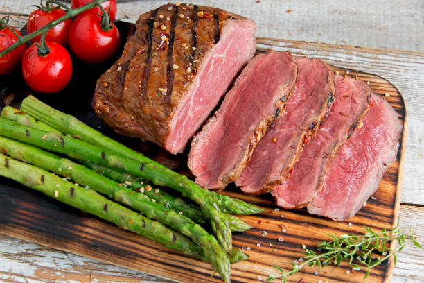 istock Fresh grilled meat.Grilled beef steak slicing medium rare , asparagus, tomato 1010697554
