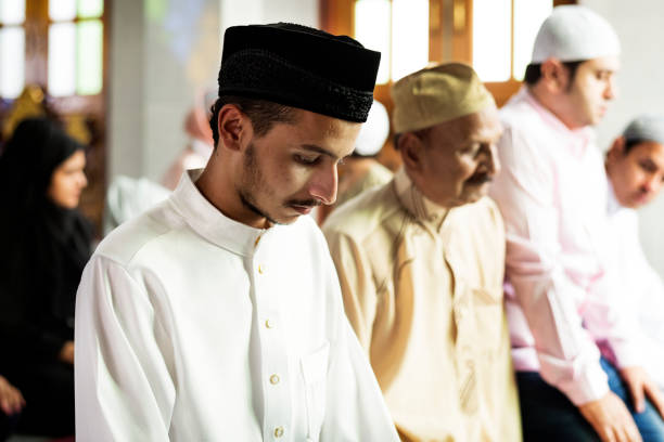 istock Muslim prayers in Tashahhud posture 1010697718
