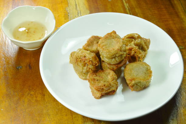 istock crispy deep fried crab meat roll in flour dipping with plum sauce 1010701594