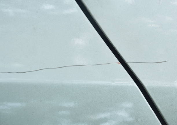 istock scratch from accident on silver color car background and texture 1010702874