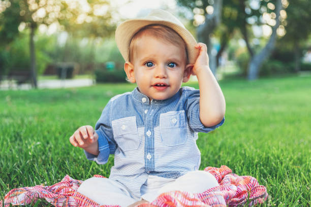istock Baby boy sitting in grass 1010726002