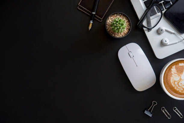 istock Office black desk table with computer, supplies and coffee cup 1010726346
