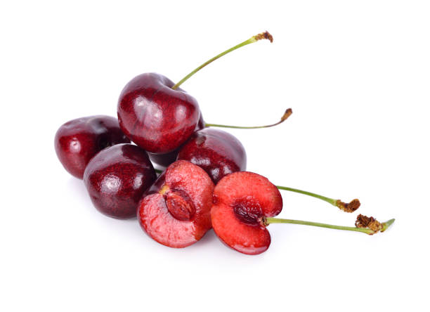 istock whole and half cut fresh cherry with stem on white background 1010738938