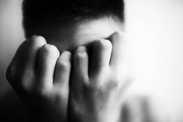 istock Boy teenager covers his face with his hands 1010745896
