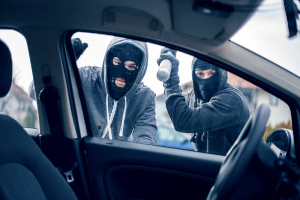 istock Burglar with baseball bat trying to enter car 1010748044