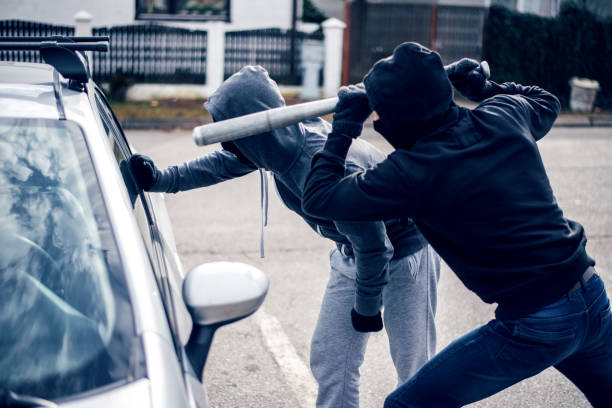 istock Burglar with baseball bat trying to enter car 1010750142