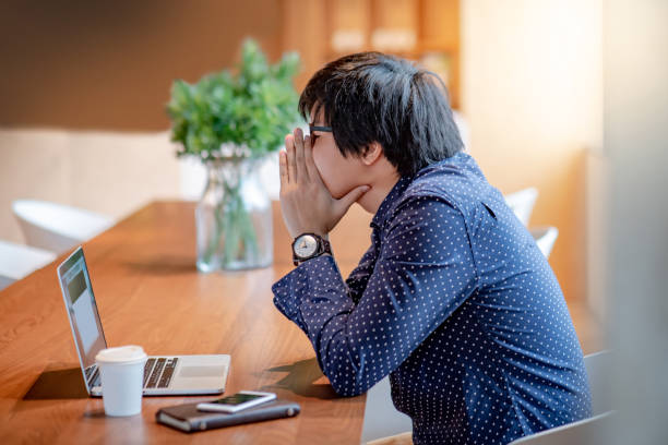 istock Young Asian businessman feeling stressed and frustrated while working with laptop computer in workplace. overworked and depression from job problem concepts 1010751718