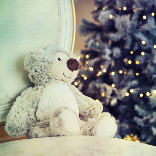 istock Toy bear against christmas tree background 1010754212