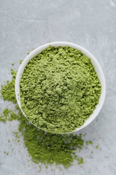 istock Green matcha tea powder in white bowl 1010754452
