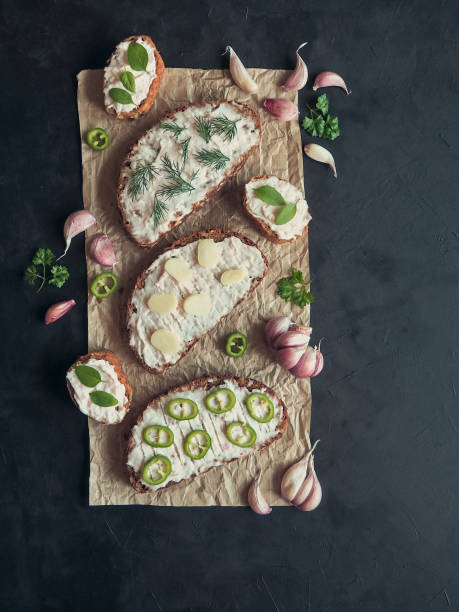 istock Pepper and garlic snacks on crumpled paper. The spread on the bread. Top view. 1010755614