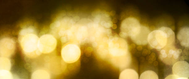 istock Christmas Gold light background.  Holiday glowing backdrop. Defocused Background With Blinking Stars. Blurred Bokeh. 1010760294