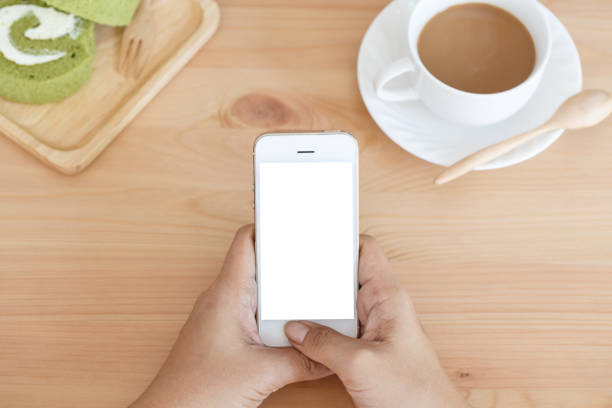istock Hand young woman holding mobile smart phone with blank screen in cafe 1010760330