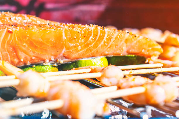 grilled salmon, salmon on barbecue with lemon infusion, sea food on grill healthy - lemon fruit portion citrus fruit imagens e fotografias de stock