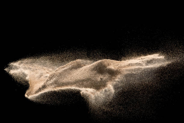istock Golden sand explosion isolated on black background. Abstract sand cloud. 1010770722