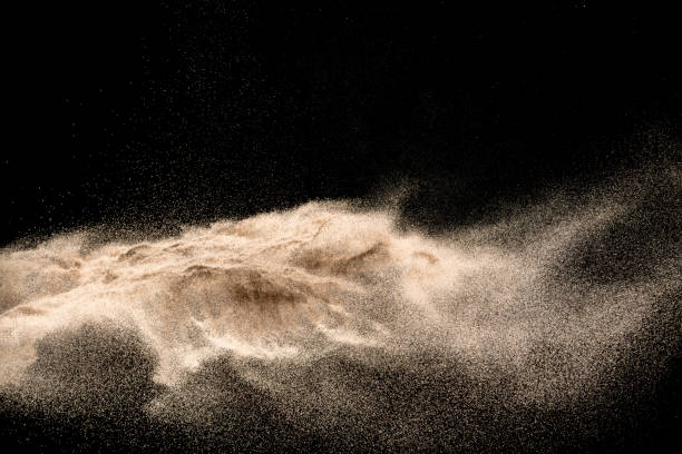 istock Golden sand explosion isolated on black background. Abstract sand cloud. 1010770726