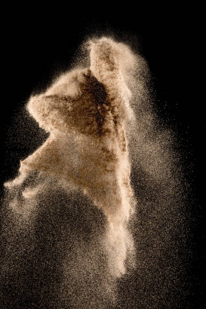 istock Golden sand explosion isolated on black background. Abstract sand cloud. 1010770750
