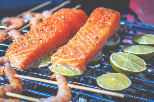 grilled salmon, salmon on barbecue with lemon infusion, sea food on grill healthy grilled salmon, salmon on barbecue with lemon infusion, sea food on grill healthy barbecue sockeye salmon filet stock pictures, royalty-free photos & images