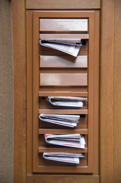 istock Mail boxes filled with advertising newspapers closeup 1010771366