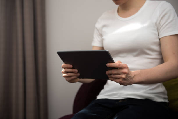 istock Young woman looking at a modern digital tablet computer background picture with copy space 1010774188