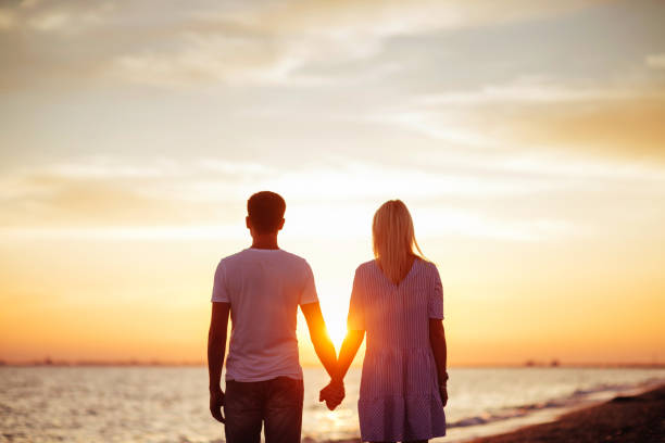 istock Young happy couple on seashore. 1010786196