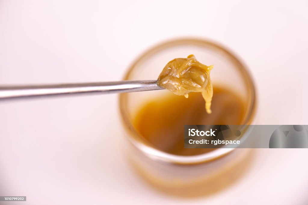 Cannabis concentrate extracted from the marijuana plant isolated on white Detail of cannabis concentrate extracted from the marijuana plant for medical use, isolated over white background Cannabis - Narcotic Stock Photo