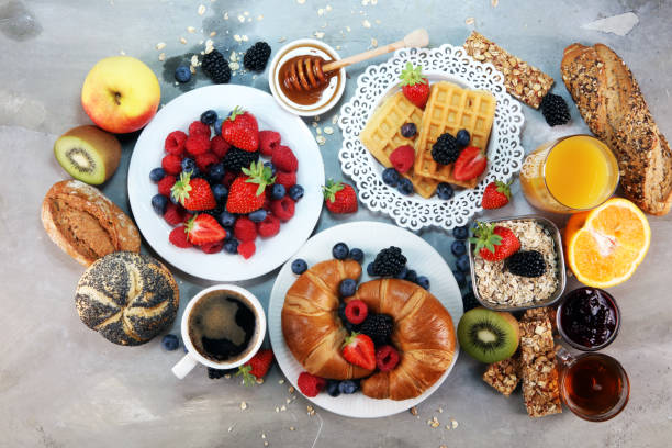 istock breakfast on table with waffles, croissants, coffe and juice. 1010800198