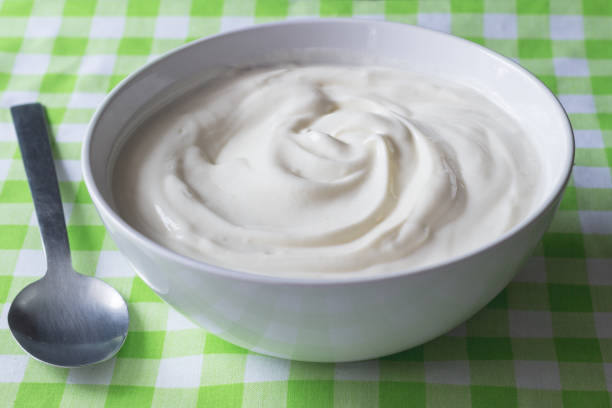 istock Natural plain white Greek yoghurt in bowl closeup - Yogurt background 1010820936