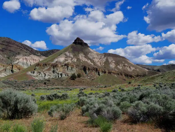 Sheep Rock Mountain with Blue Sky and Fluffy Clouds