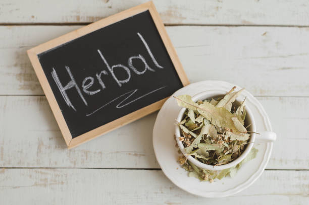 istock Dried lime flowers in a white tea cup and framed blackboard with text 
