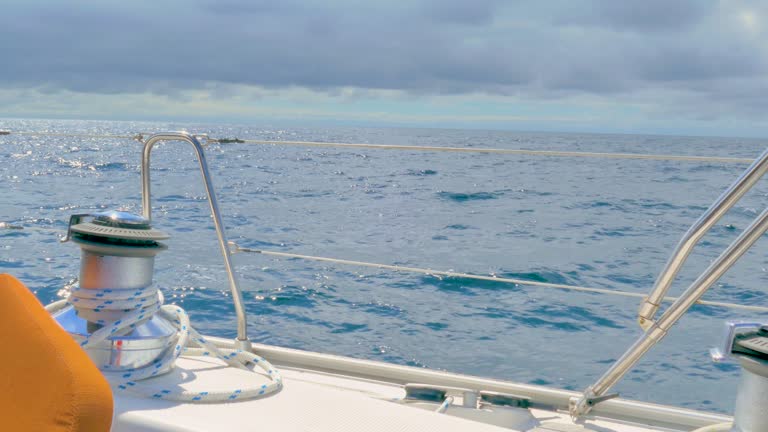 Sail boat winch with rope while sailing in the Atlantic ocean