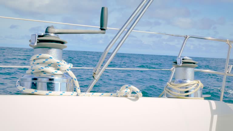 Sail boat winch with rope while sailing in the Atlantic ocean