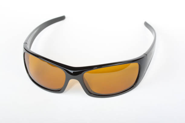 istock Sunglasses with black plastic frame and yellow glass on a white background 1010833158