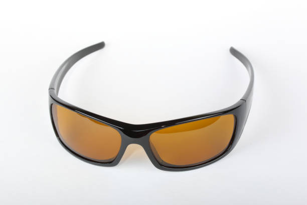 istock Sunglasses with black plastic frame and yellow glass on a white background 1010833200