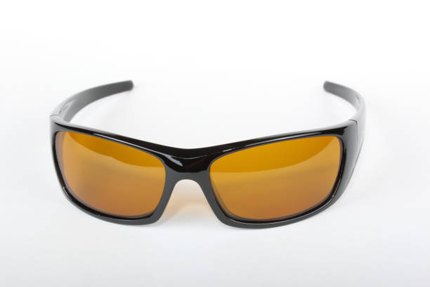 istock Sunglasses with black plastic frame and yellow glass on a white background 1010833224