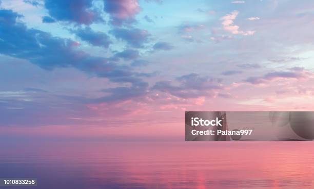 Misty Lilac Seascape With Pink Clouds Stock Photo - Download Image Now - Sky, Sunset, Pink Color