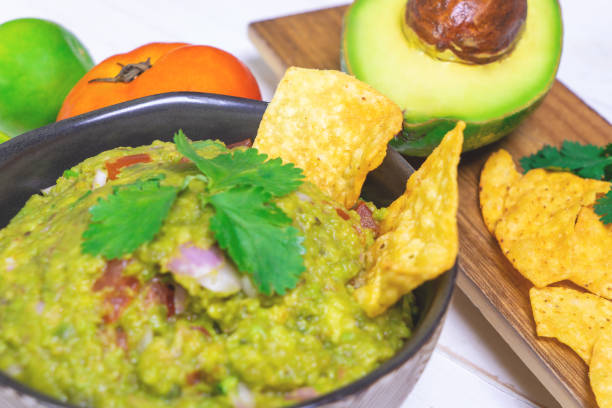 istock Mexican style serve of Mexican avocado guacamole with chips 1010833318