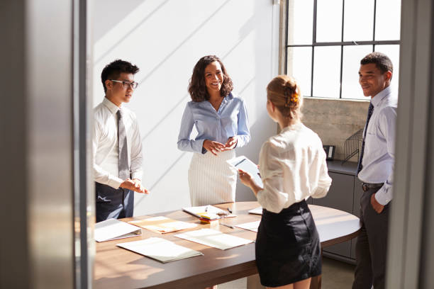 istock Four business colleagues working together in a small office 1010836016