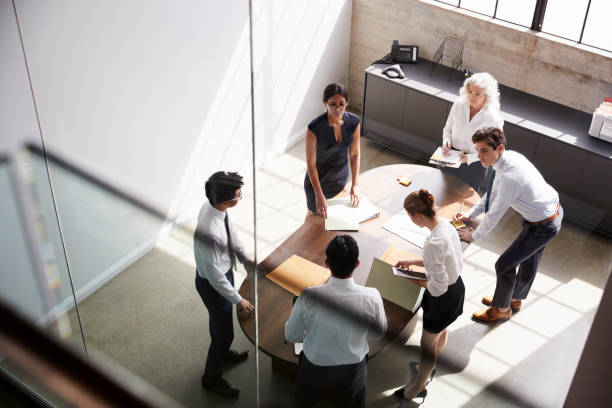 istock Female manager and business team in meeting, elevated view 1010836174