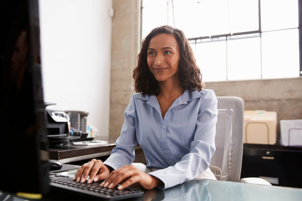 istock Young mixed race woman using computer at office desk 1010837160
